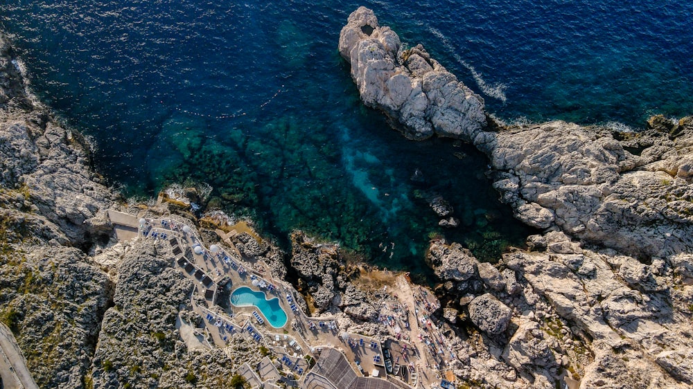 an aerial view of a pool in the middle of the ocean