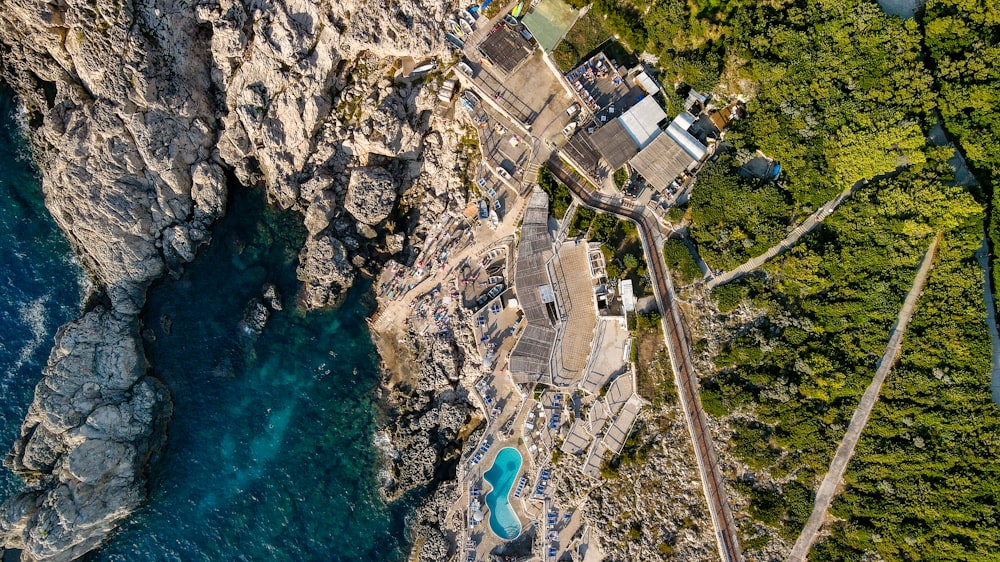 an aerial view of a cliff with a swimming pool