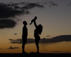 a silhouette of a man and a woman holding a baby