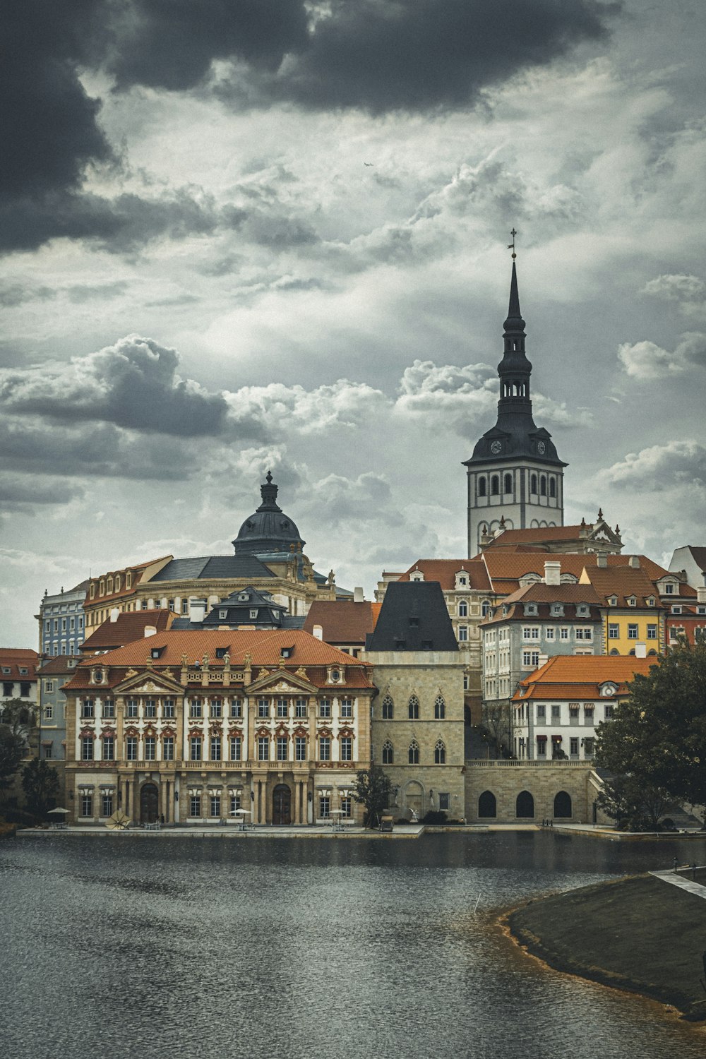 a large building with a clock tower next to a body of water