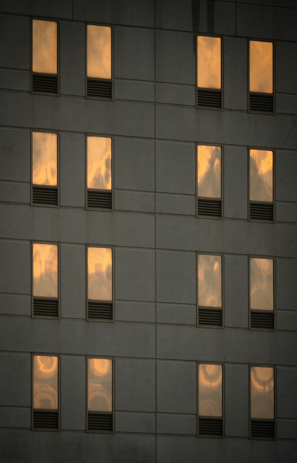 a building with many windows reflecting the sky