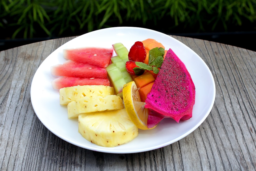 a white plate topped with cut up fruit