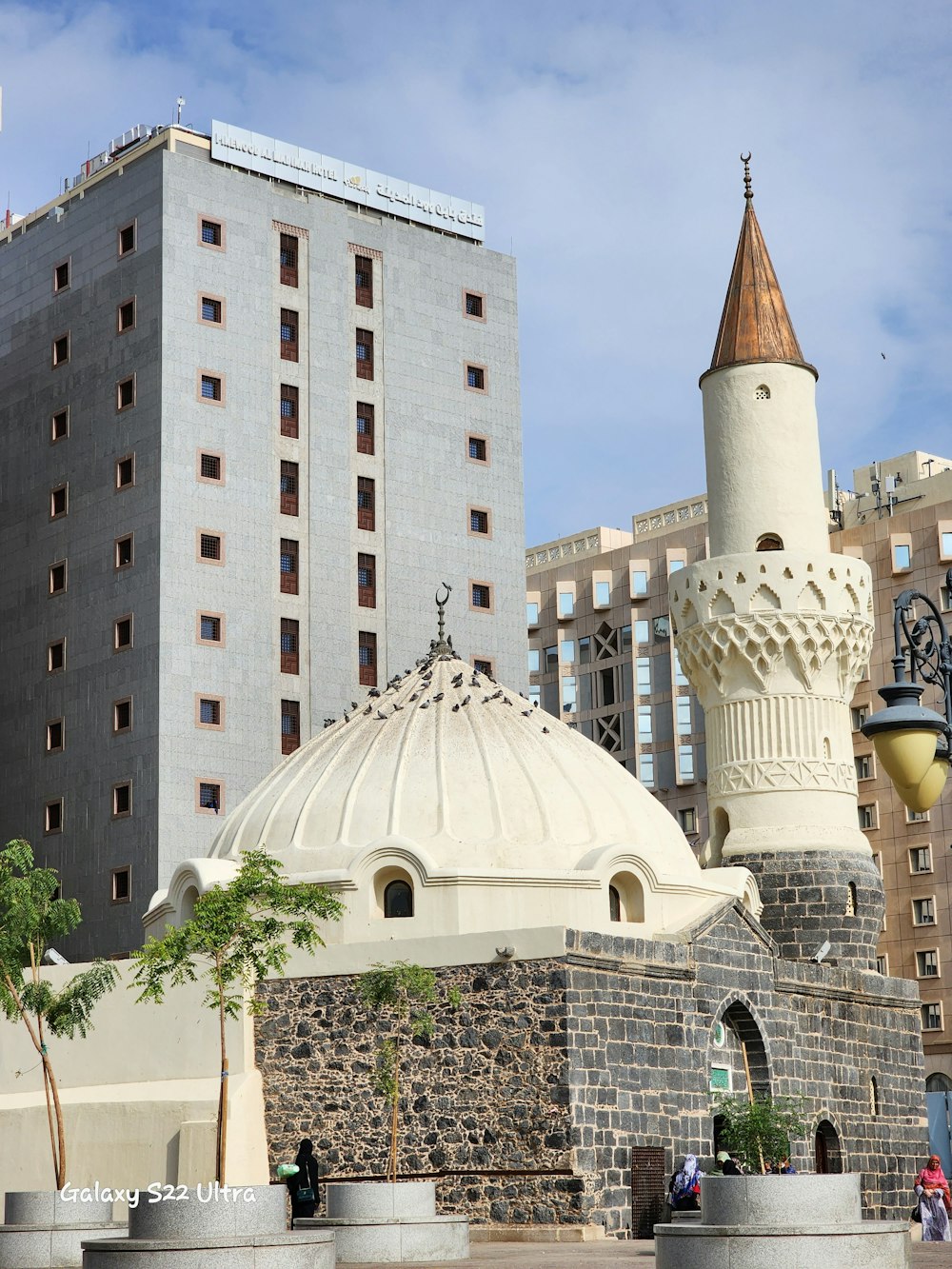 a large white building with a clock on it's side