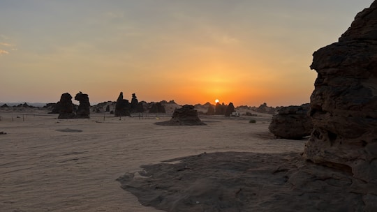 A picturesque desert landscape in Jordan with a small guided tour group exploring at sunset.