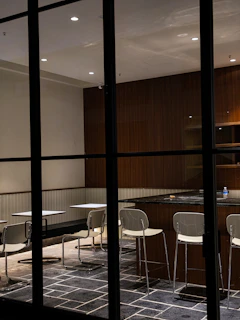 A modern dining area with a modular table and chairs designed for easy rearrangement and comfort.