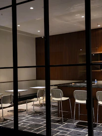 A modern dining area with a modular table and chairs designed for easy rearrangement and comfort.