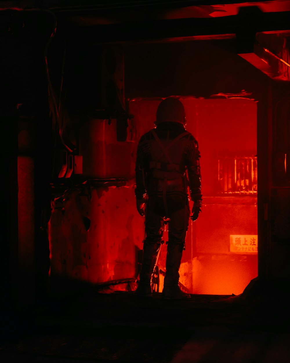 a man standing in a room with a red light