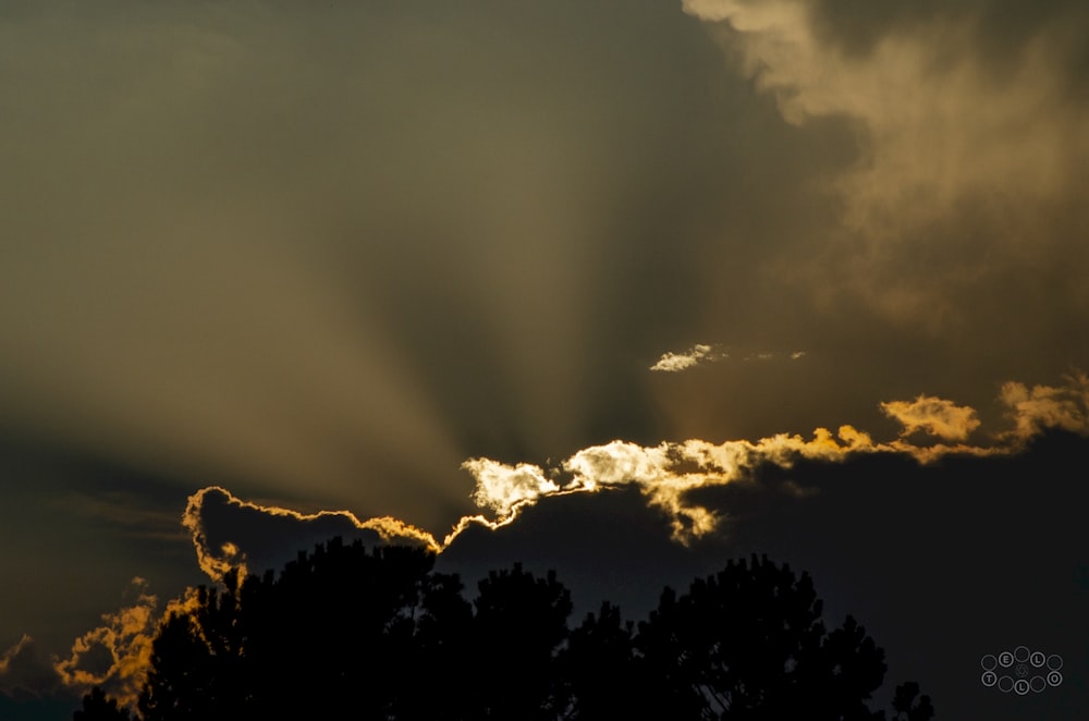 the sun is shining through the clouds in the sky