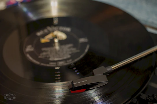 Close-up of a hand holding a vinyl record of a metal album with dark, edgy artwork.