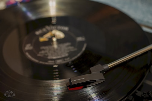 Close-up of a vinyl record spinning with elegant gold and black label design.