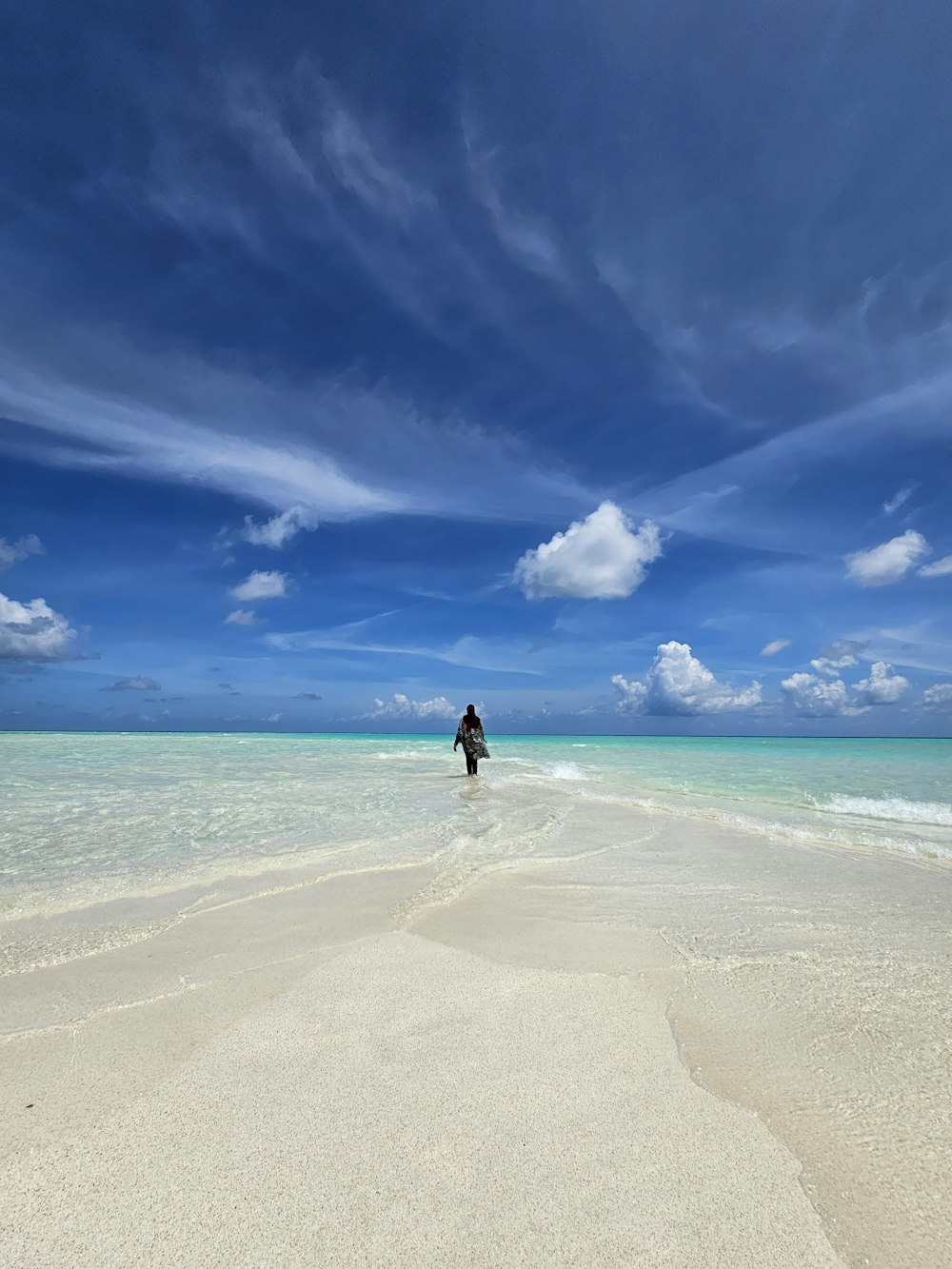 a person standing in the water on a beach