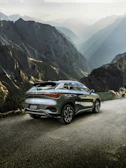 Powerful SUV parked on a mountain road with scenic views.