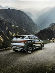 Front three-quarter view of the Tata Sierra SUV in urban bronze on a rugged mountain trail.