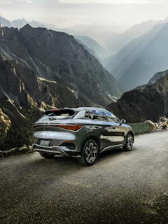 Luxury SUV gleaming under the morning sun in a mountain setting