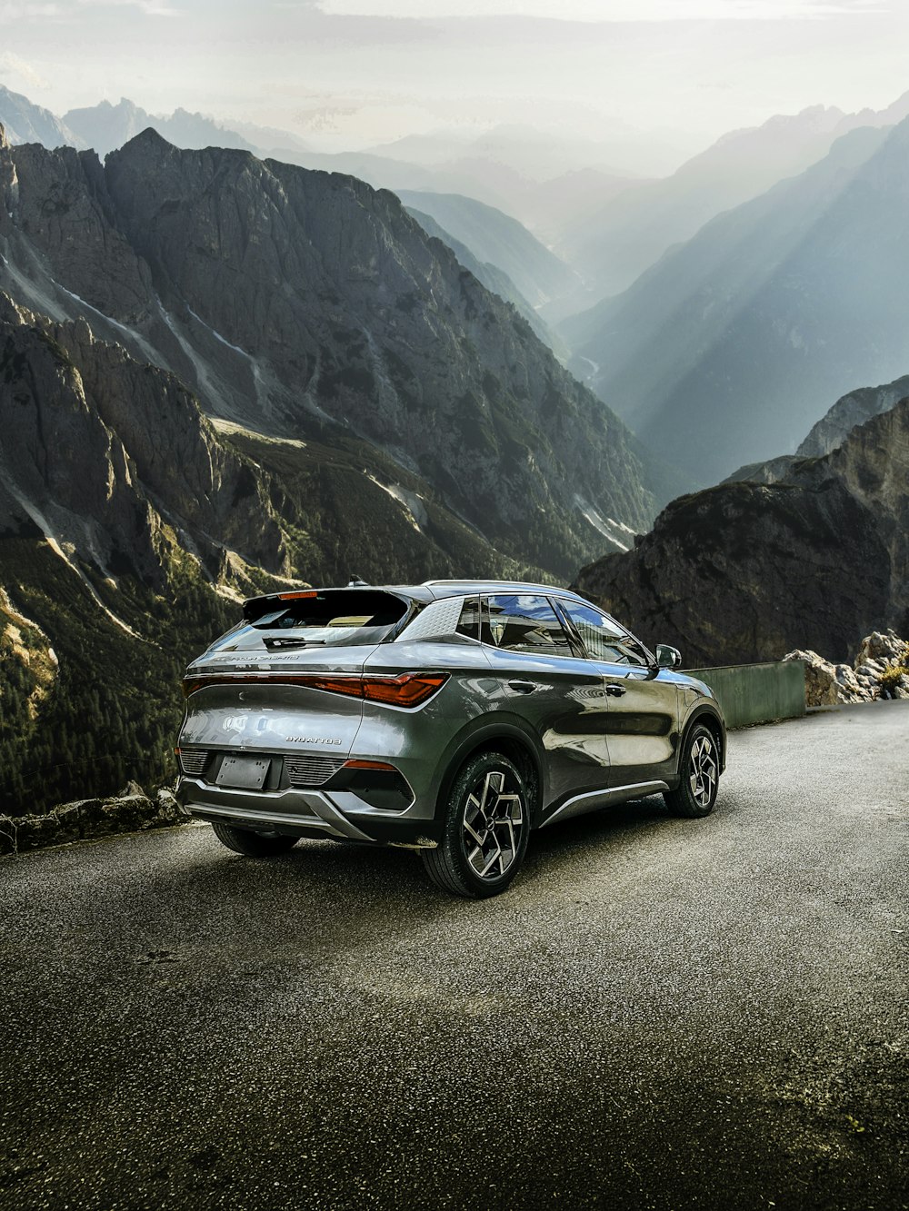 a car parked on the side of a mountain road