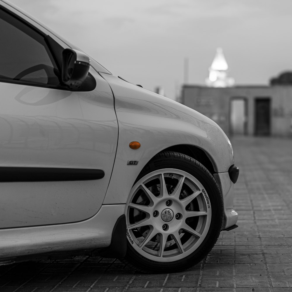 a white car parked on a brick road