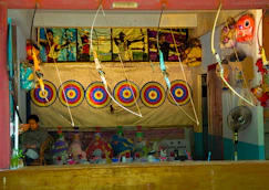 Various archery accessories like quivers, armguards, and finger tabs neatly displayed.