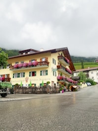 A cozy homestay building exterior in Yogyakarta with purple and pink accents.