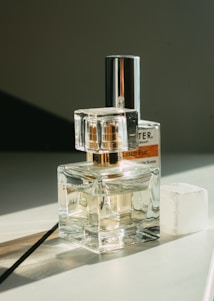 Minimalist luxury perfume bottles arranged elegantly on a sleek digital interface background.