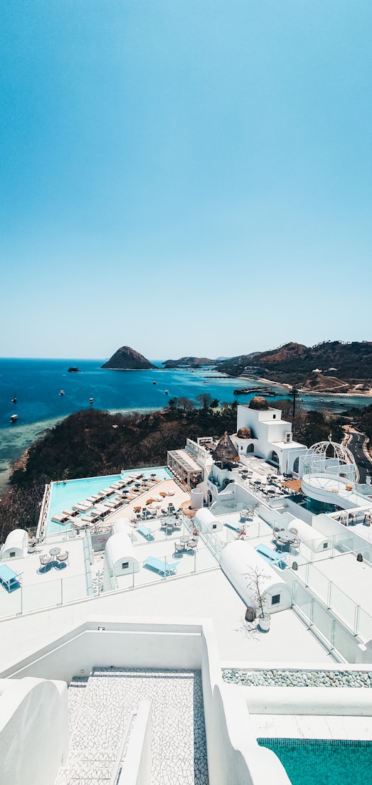 an aerial view of a resort with a swimming pool
