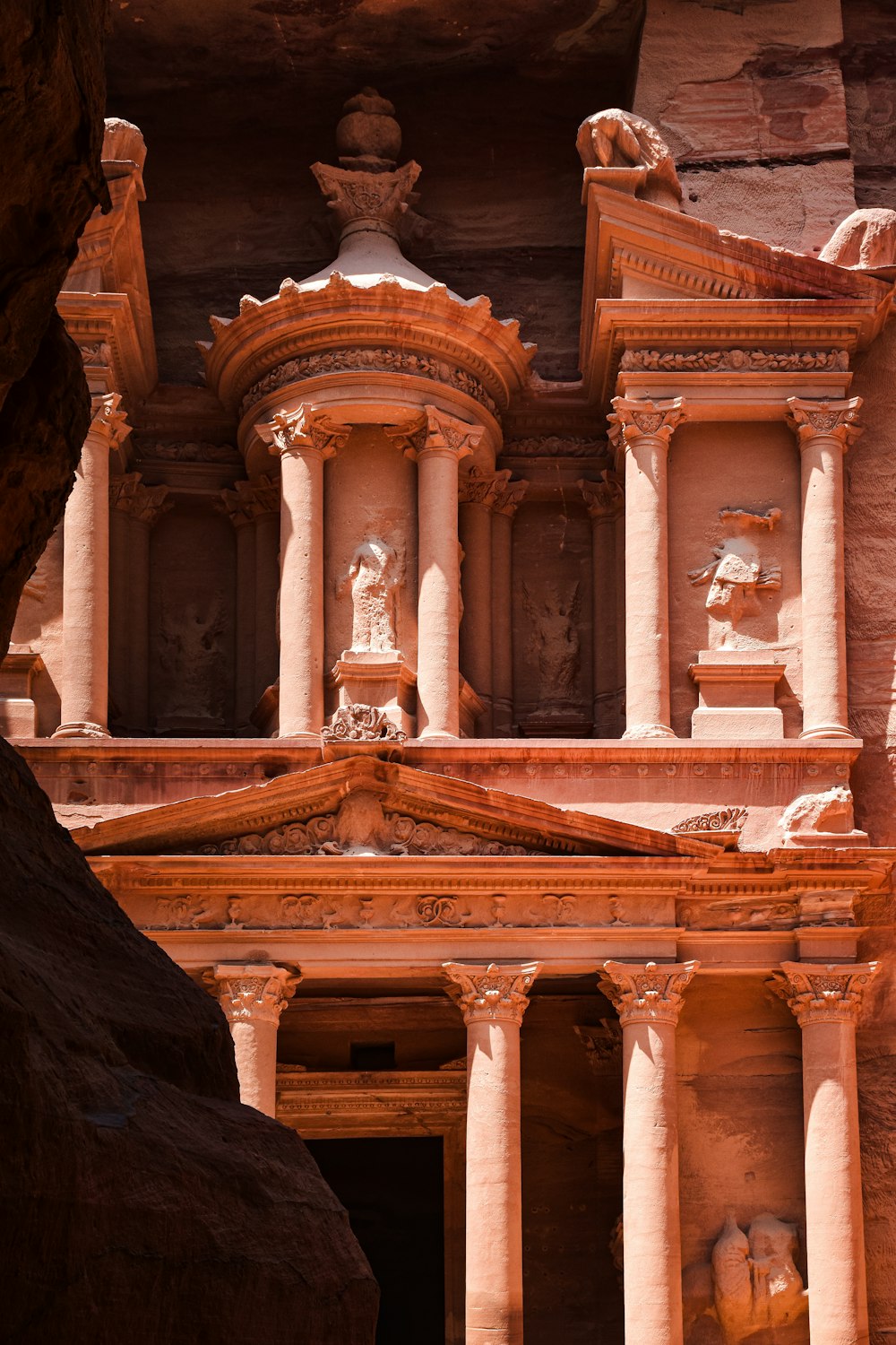 a large building with statues on the side of it