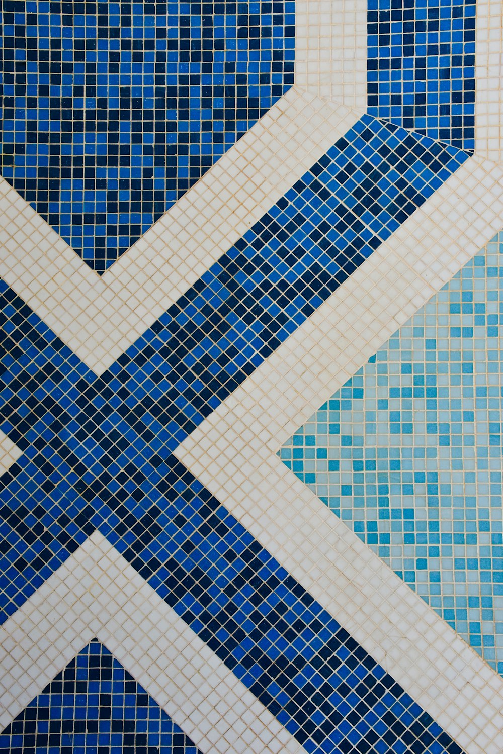 a blue and white tiled wall with a flag on it