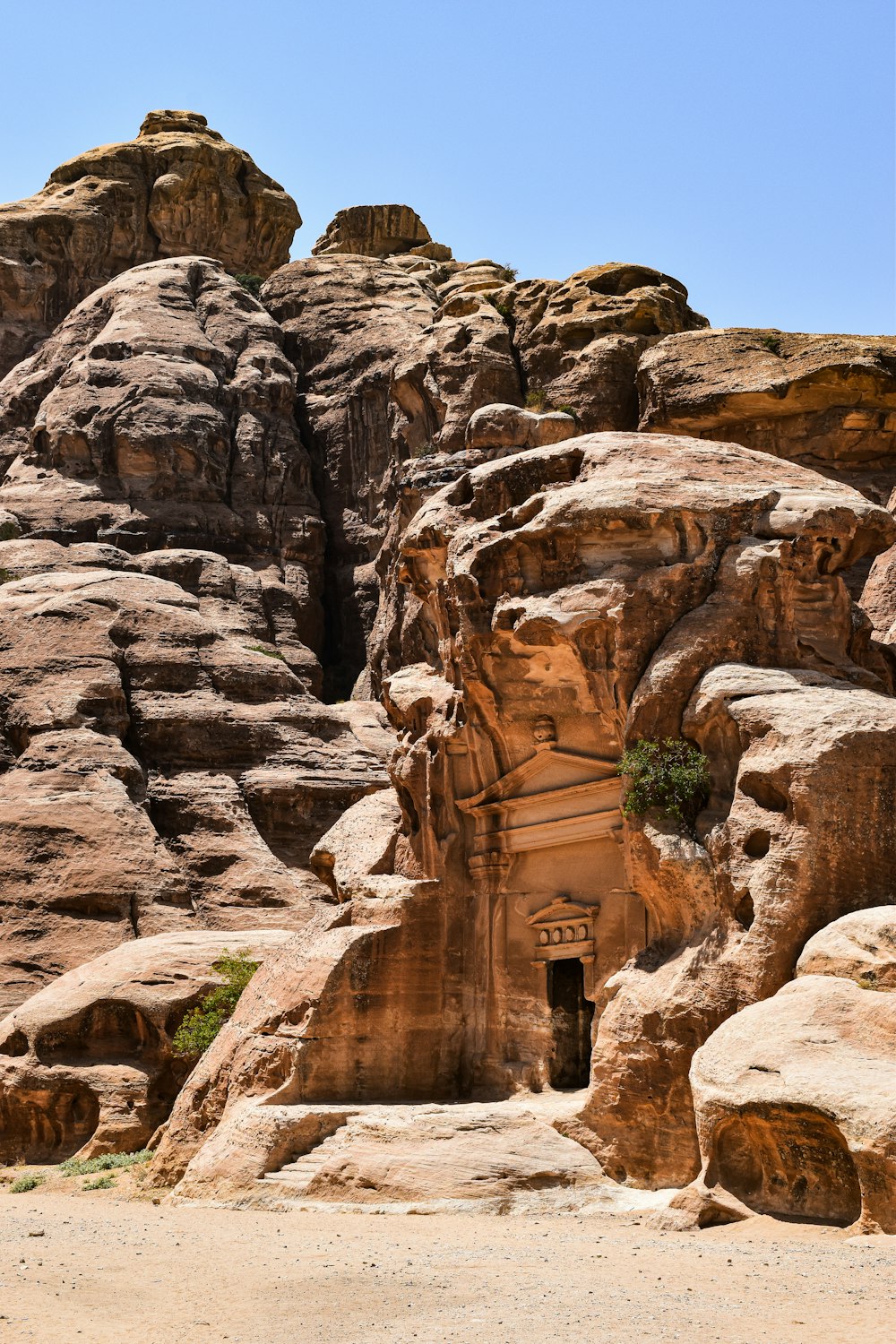 a rock formation with a doorway in the middle of it