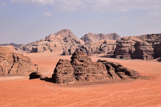 a desert landscape with rocks and sand in the foreground