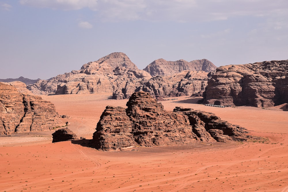 a desert landscape with rocks and sand in the foreground