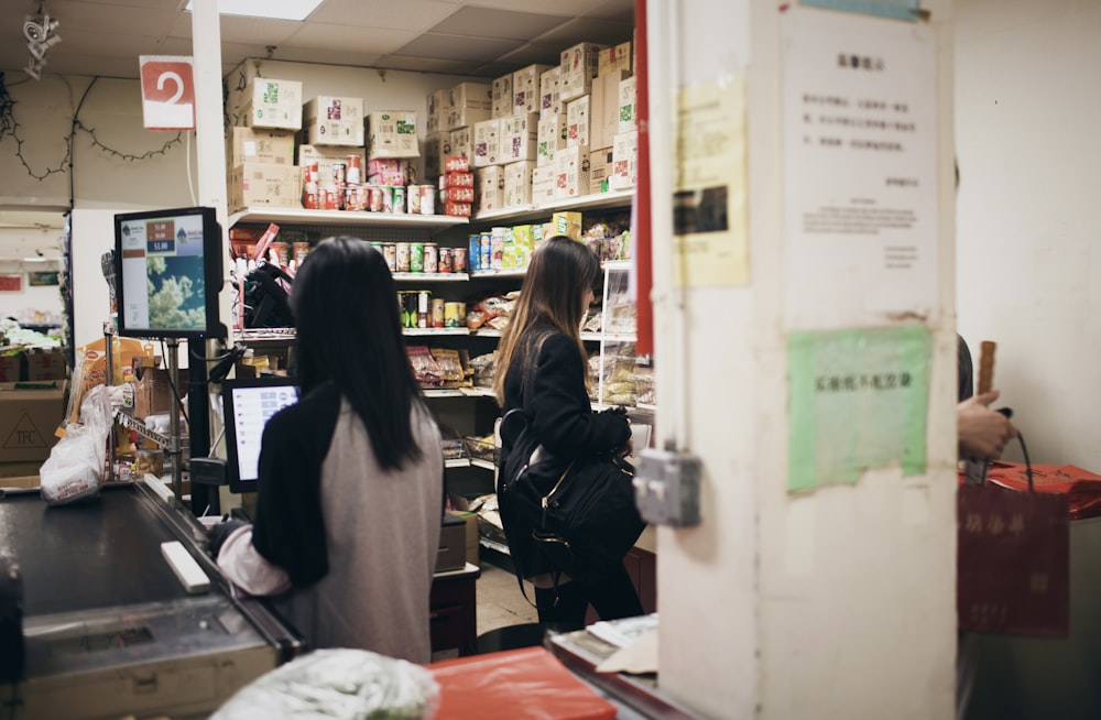 a couple of women standing in a store