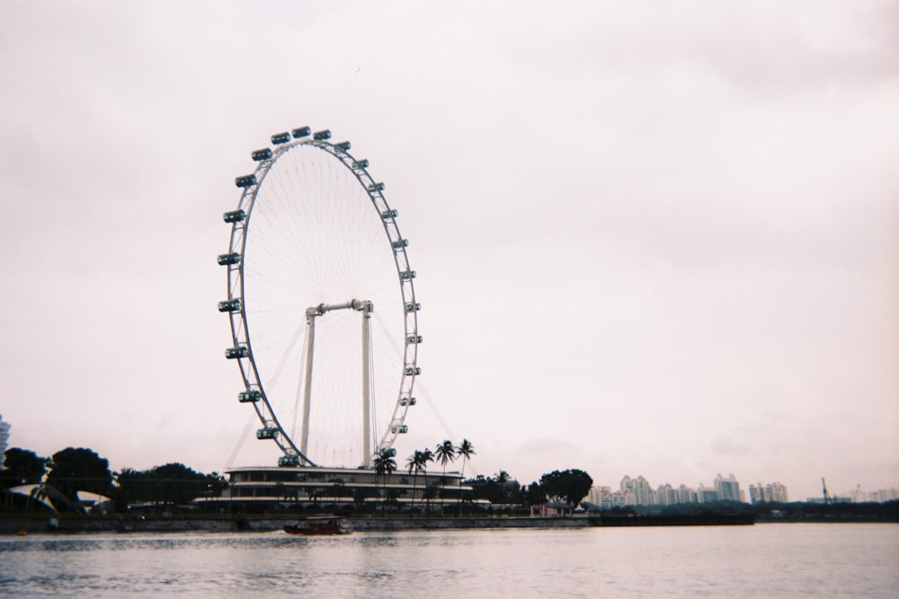 a large ferris wheel in the middle of a body of water