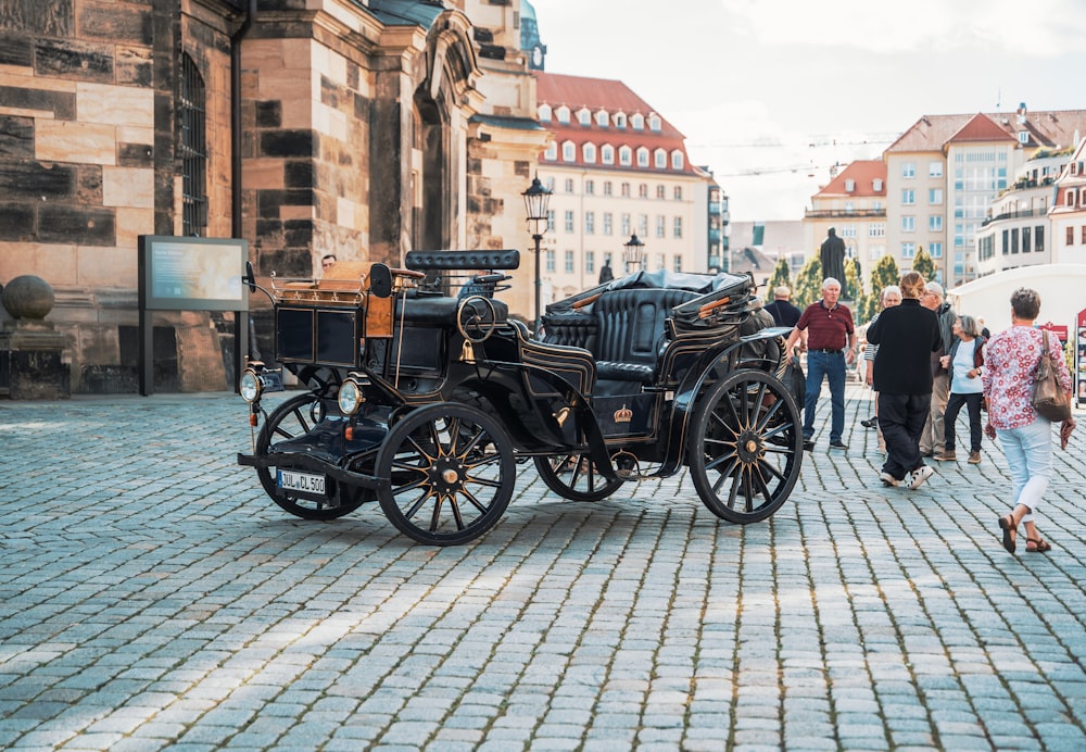 a group of people walking down a cobblestone street