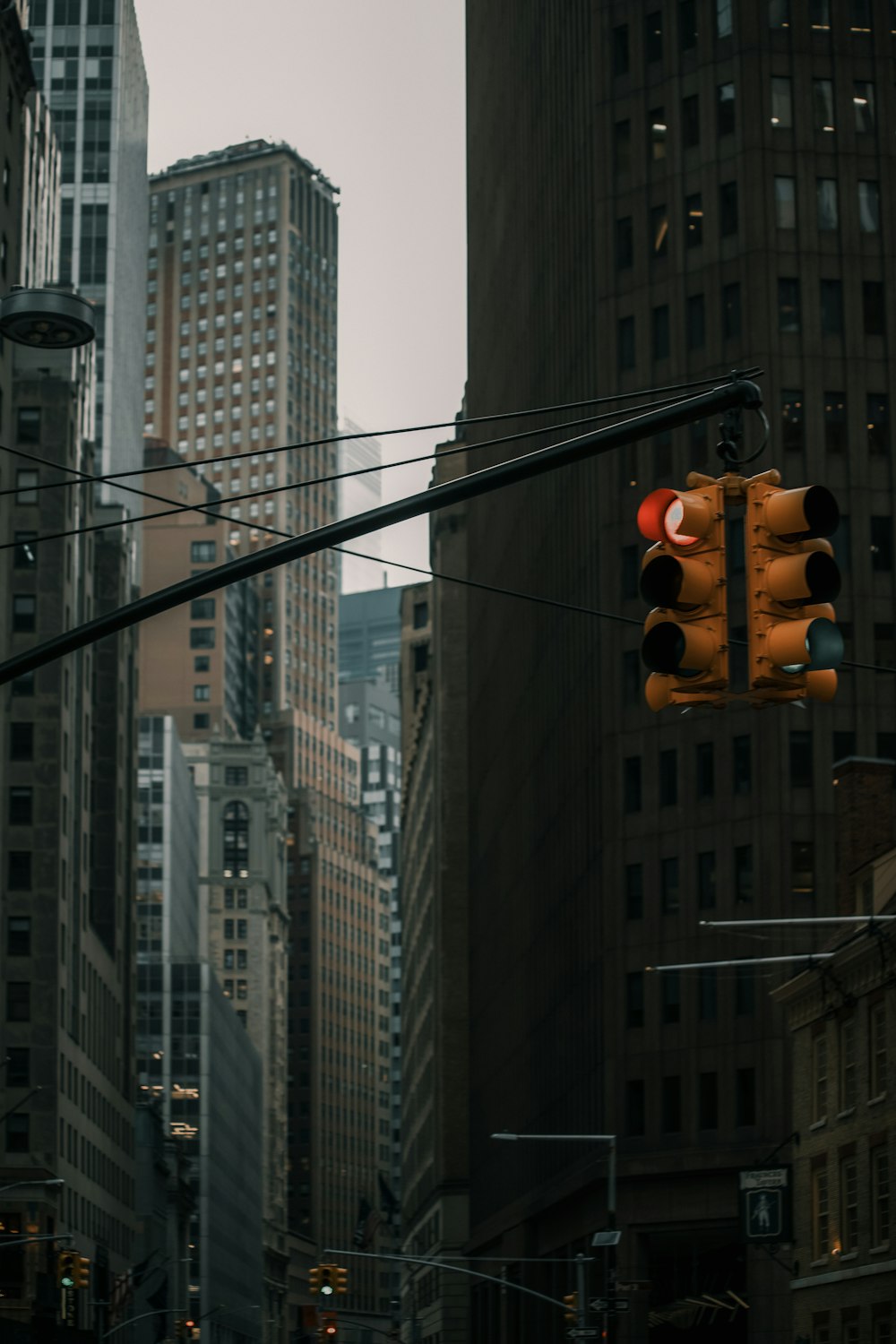 a traffic light hanging from a pole in a city