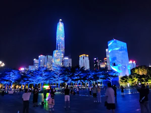 A futuristic city skyline illuminated with electric blue and green lights symbolizing clean energy.