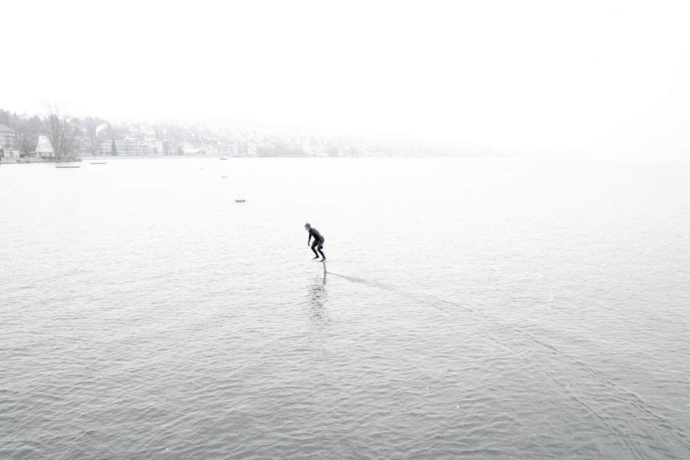 a person on a surfboard in the middle of a body of water