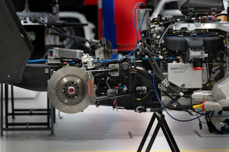 Set of brake system components including pads and discs with industrial background.