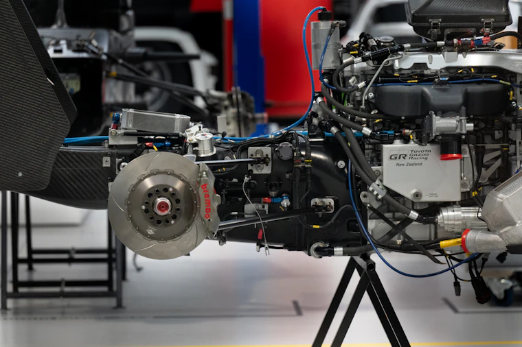 Close-up of a brake rotor and caliper on a vehicle in the shop