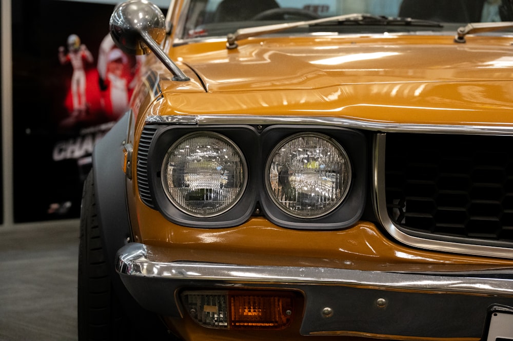 a close up of the front of a yellow car