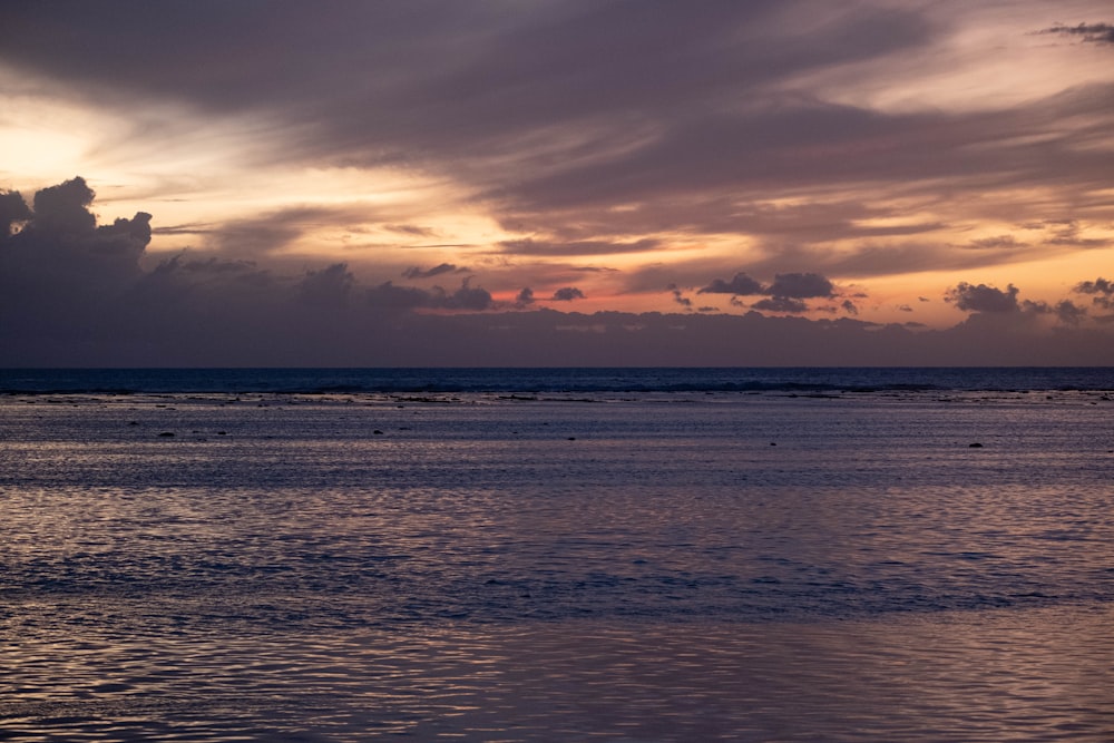 a large body of water under a cloudy sky