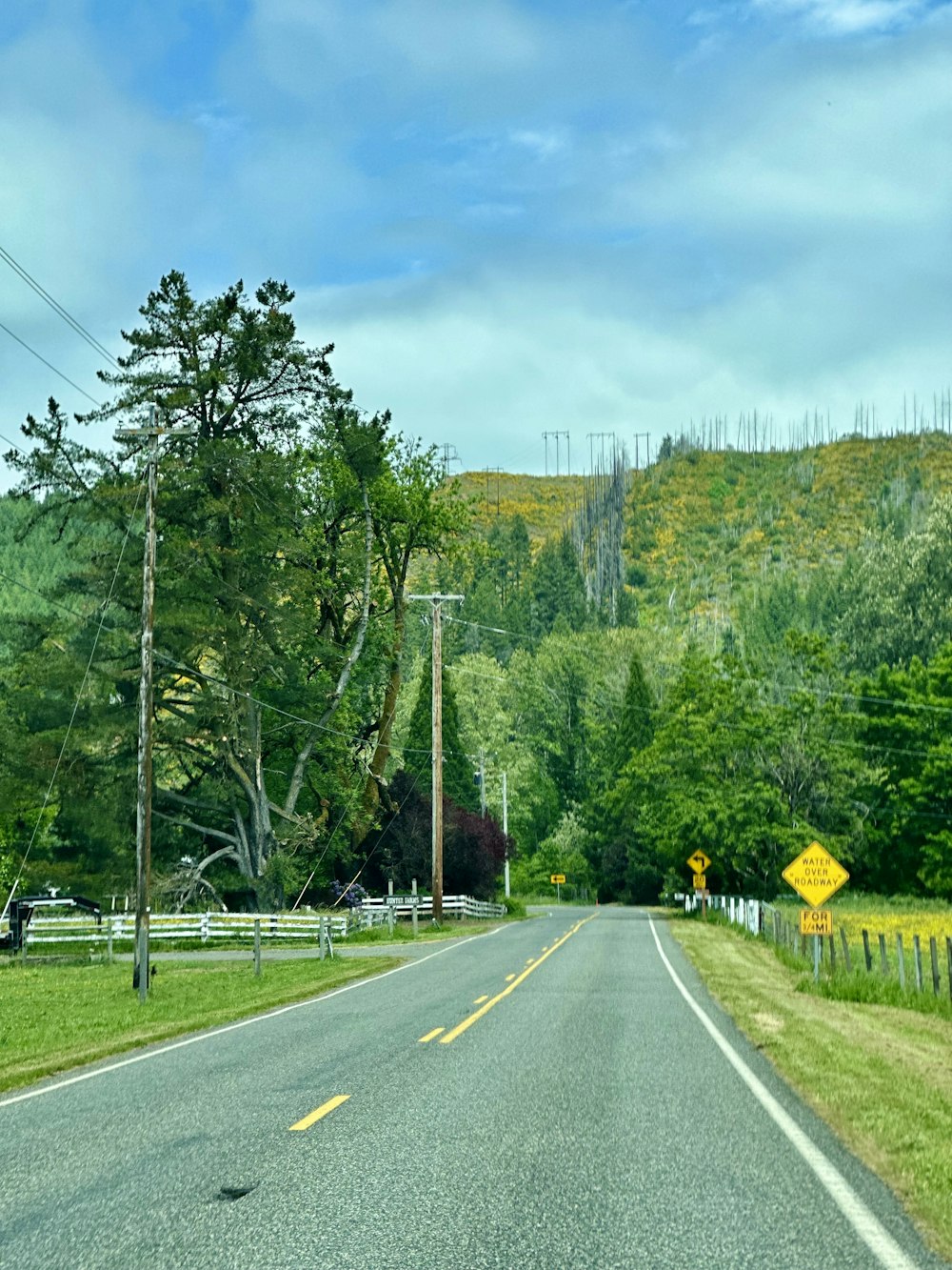 a road with a yellow sign on the side of it