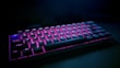Ergonomic mechanical keyboard with blue backlighting on a sleek black surface.