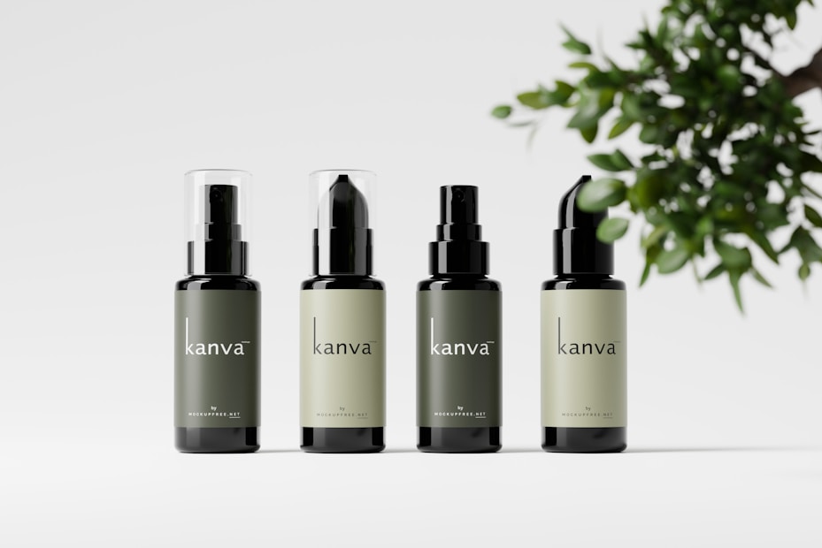 Four bottles of skincare products are arranged in a row, each with a similar design and varied in label color. The bottles have a sleek design with the brand name 'kanva' printed on them. To the right, there is a branch with green leaves providing a natural element.