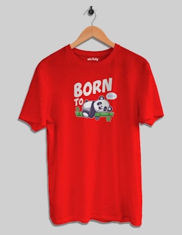 A red T-shirt is hanging on a wooden hanger against a plain background. The front of the shirt features a cartoon panda sleeping on a bamboo branch, accompanied by the words 'BORN TO' with a speech bubble saying 'Zzz...'.