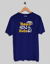 A blue t-shirt with a humorous design featuring a mustache and the text 'Baap Hota Hai!' in bold yellow and white letters. A hand holding a cigar is part of the design.