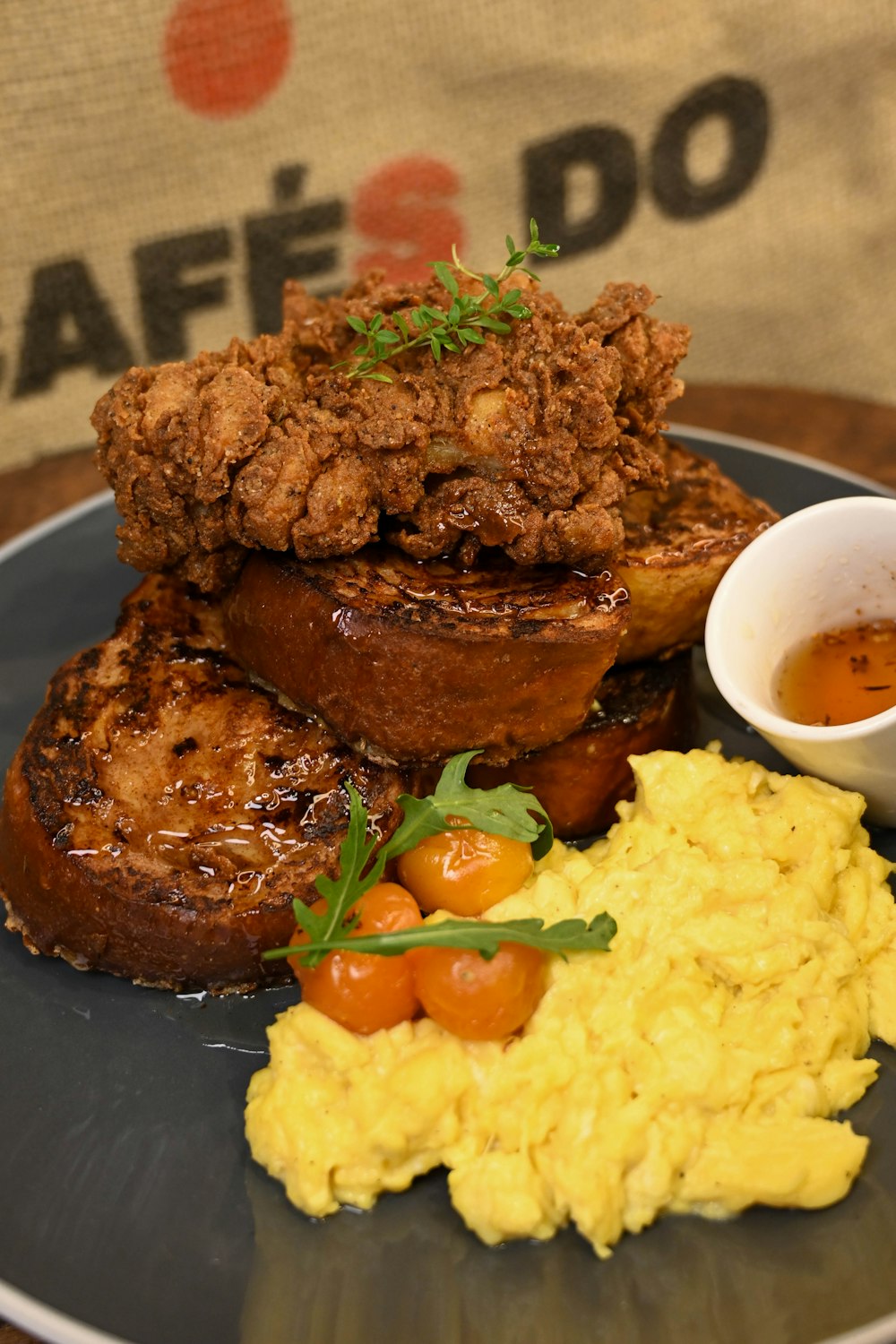 a plate of food on a table with a sign in the background