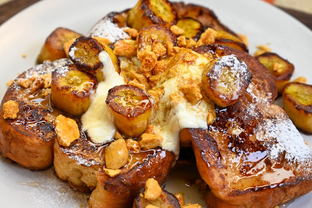 a white plate topped with french toast covered in powdered sugar