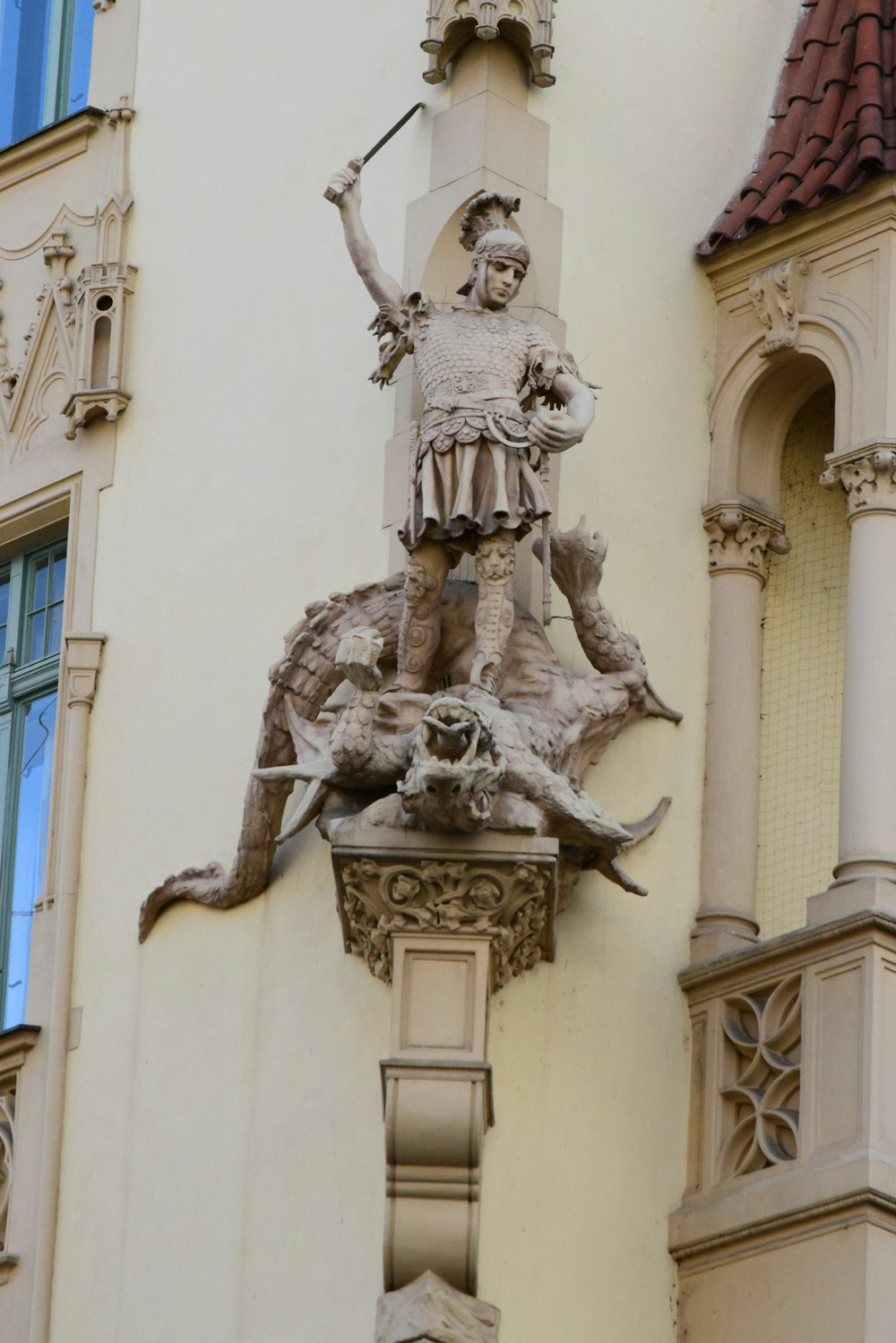 a statue of a man on a horse on the side of a building