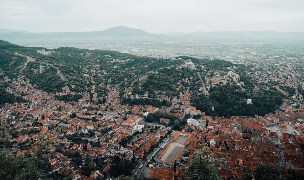 an aerial view of a city with mountains in the background