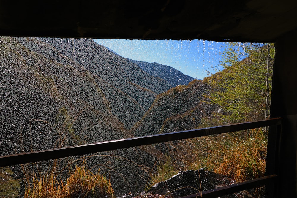 a view of a mountain range from a window