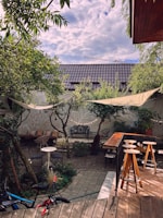 A spacious backyard with greenery and outdoor seating.